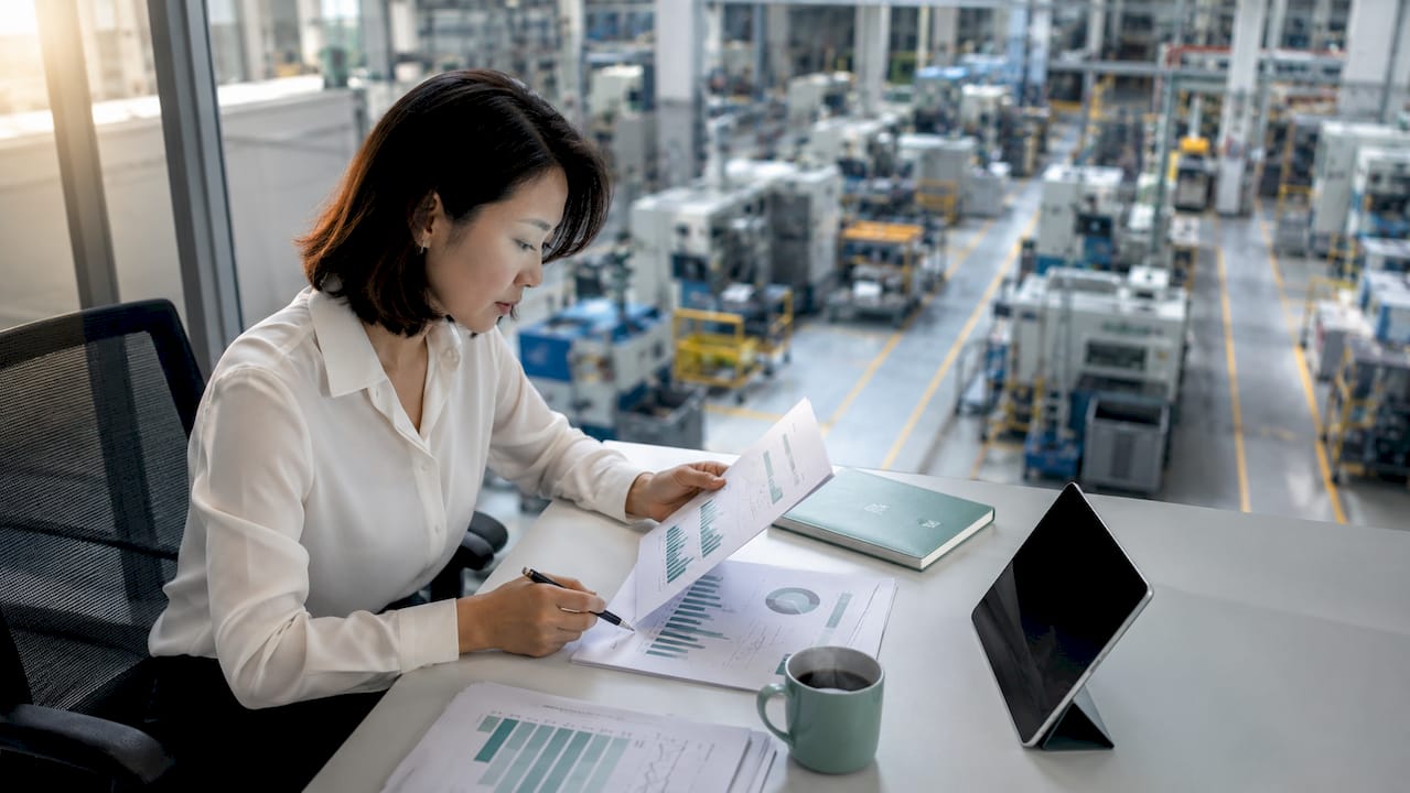 Analyst reviewing manufacturing productivity charts